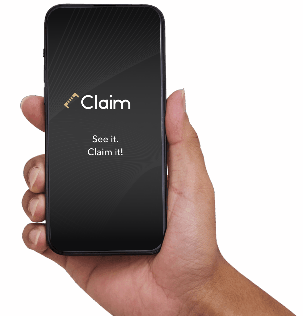 Hand holding smartphone displaying "Claim" message.