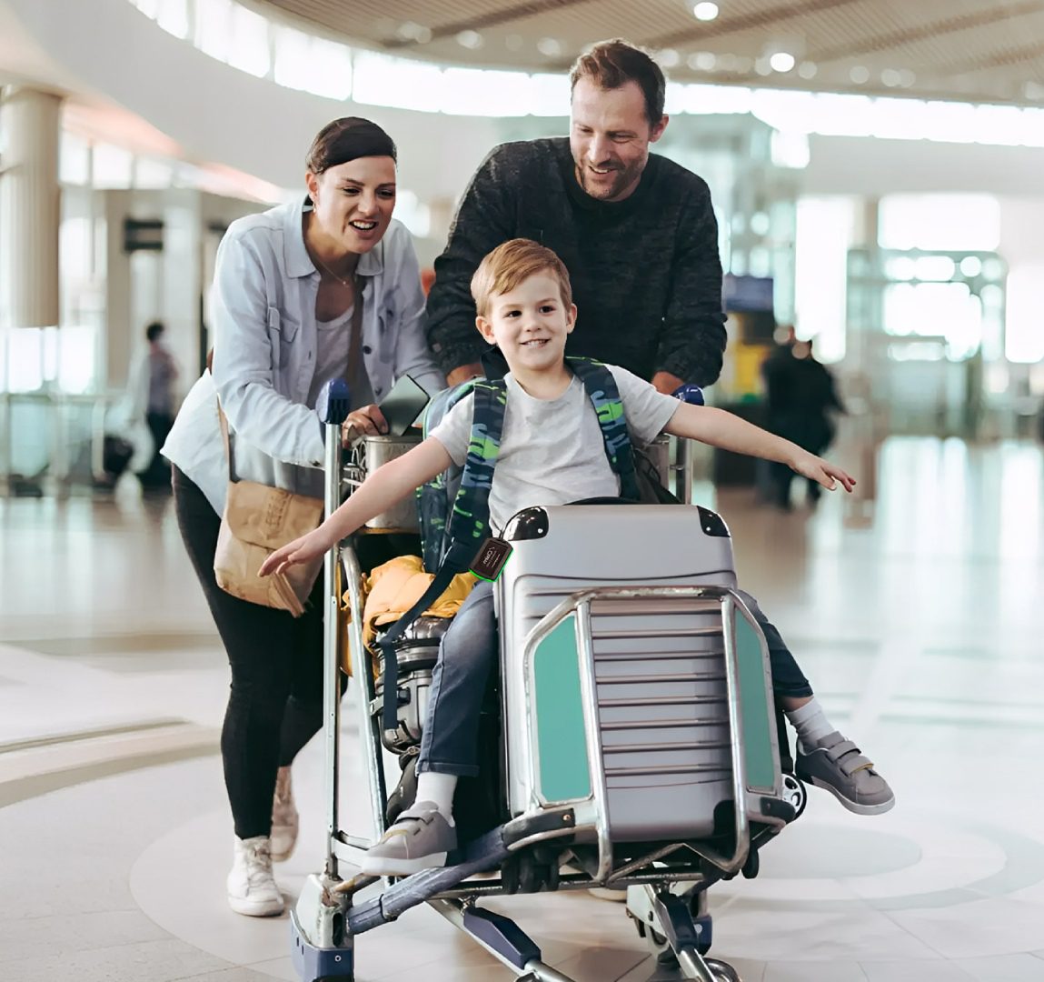 Family enjoying airport luggage cart ride.