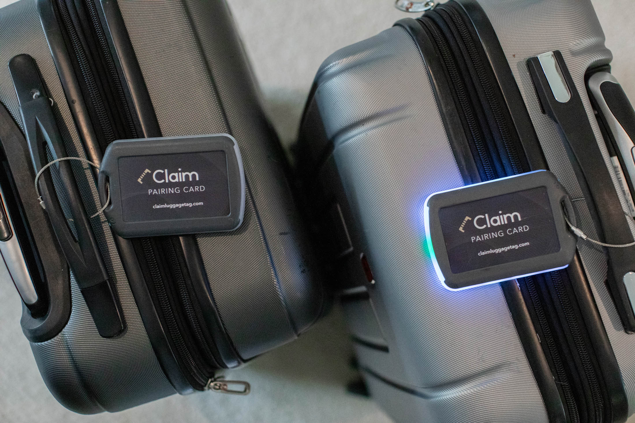 Two suitcases with electronic luggage tags.